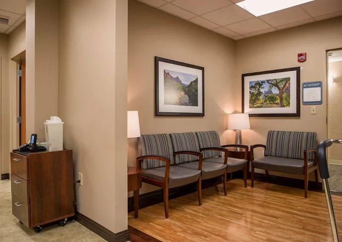 Small waiting room with chairs and framed art