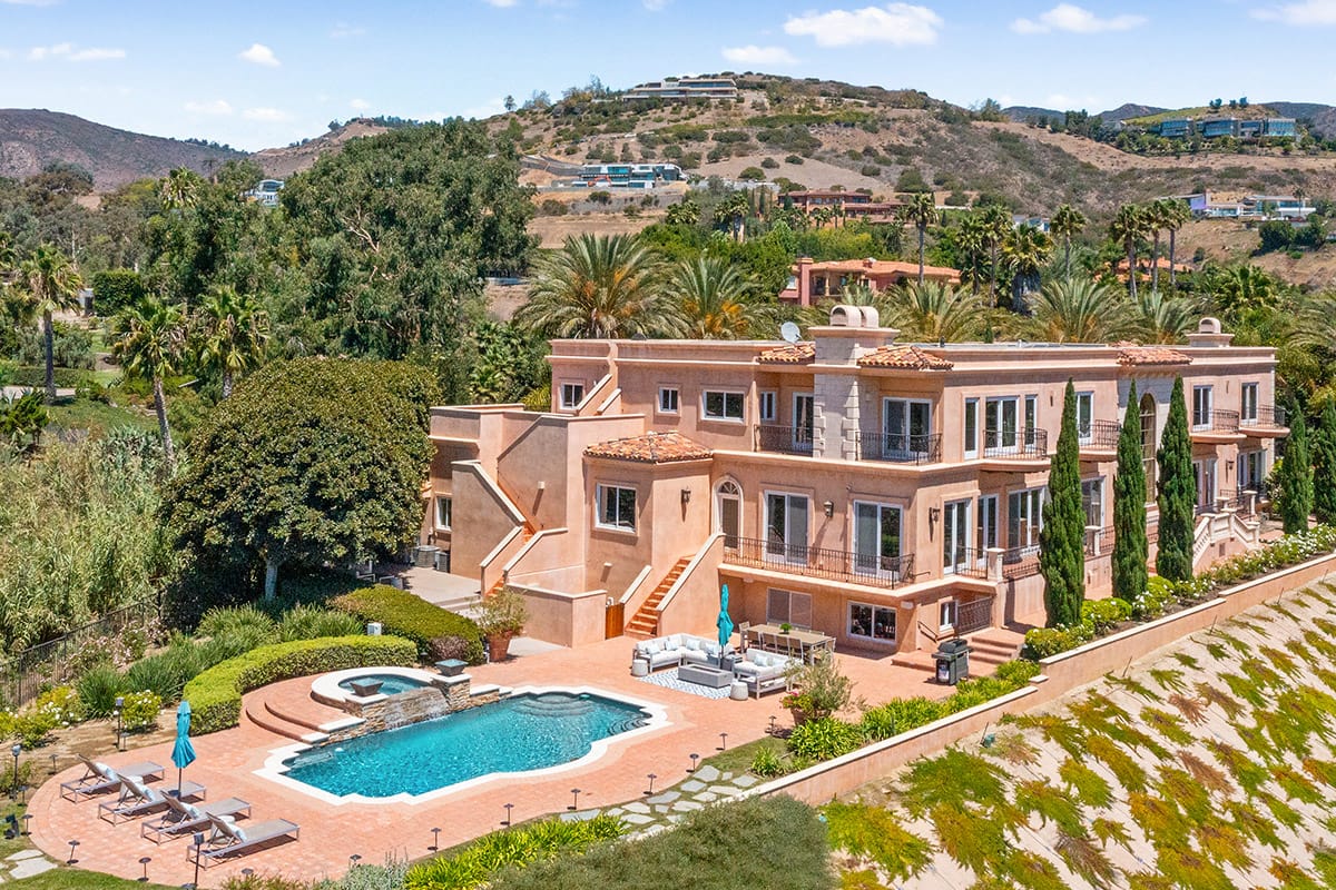 Aerial view of Serenity Malibu estate with pool and hillside setting