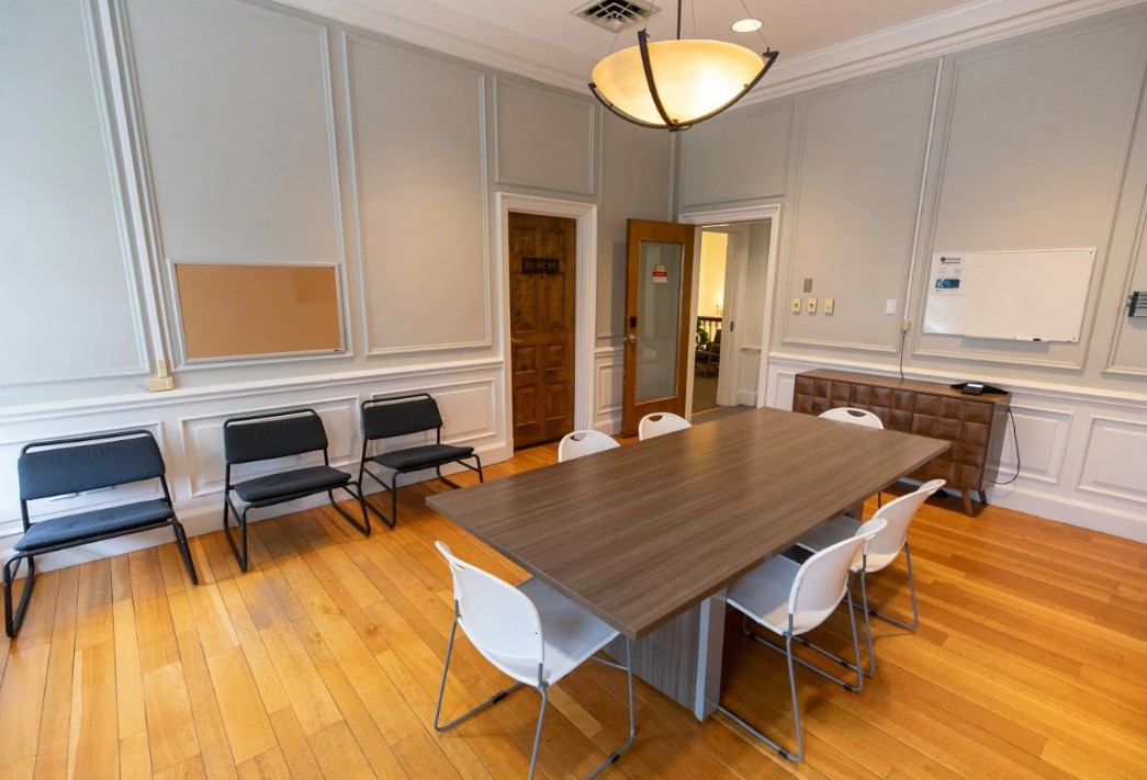 Meeting room with table, chairs, and whiteboard