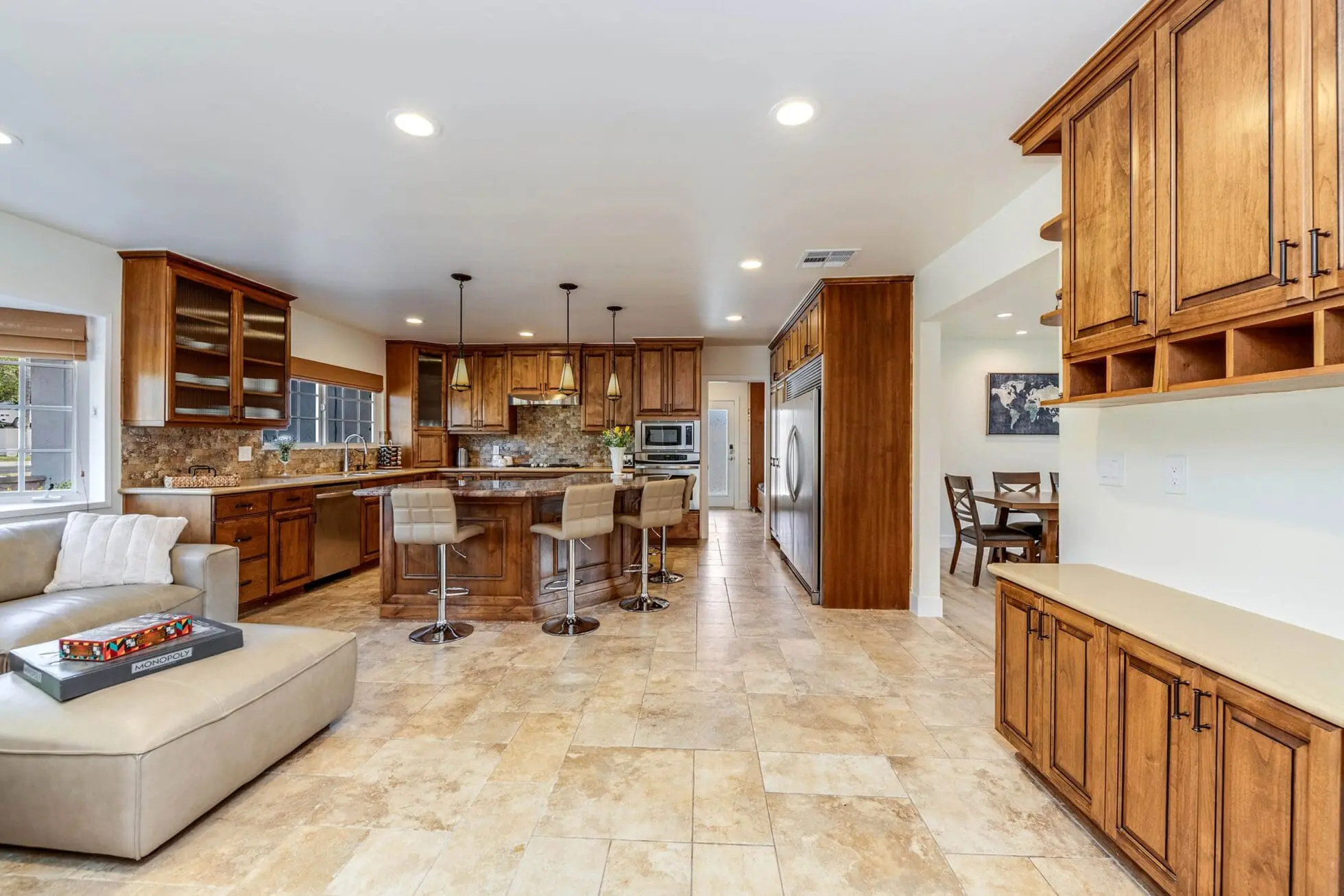 Open kitchen with wood cabinets and island seating