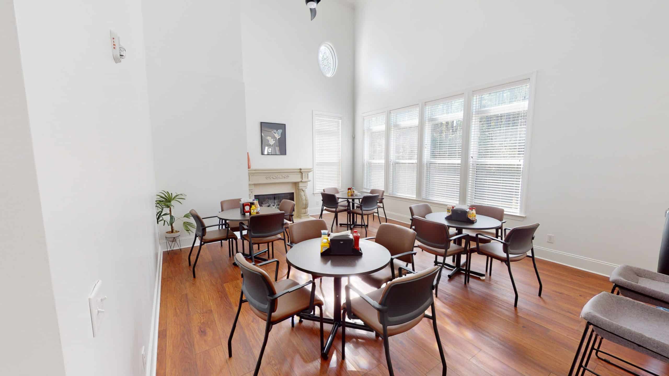 Dining room with round tables and bright windows