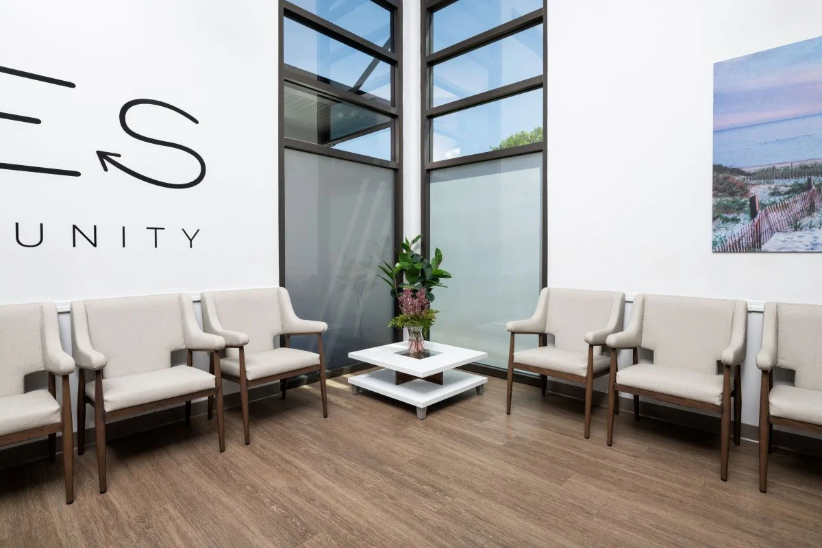 Bright waiting area with cushioned chairs and natural light.
