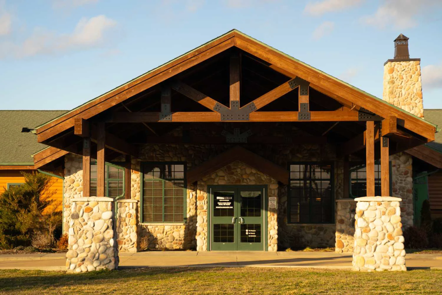 Close-up of rehab center entrance with wood and stone design.