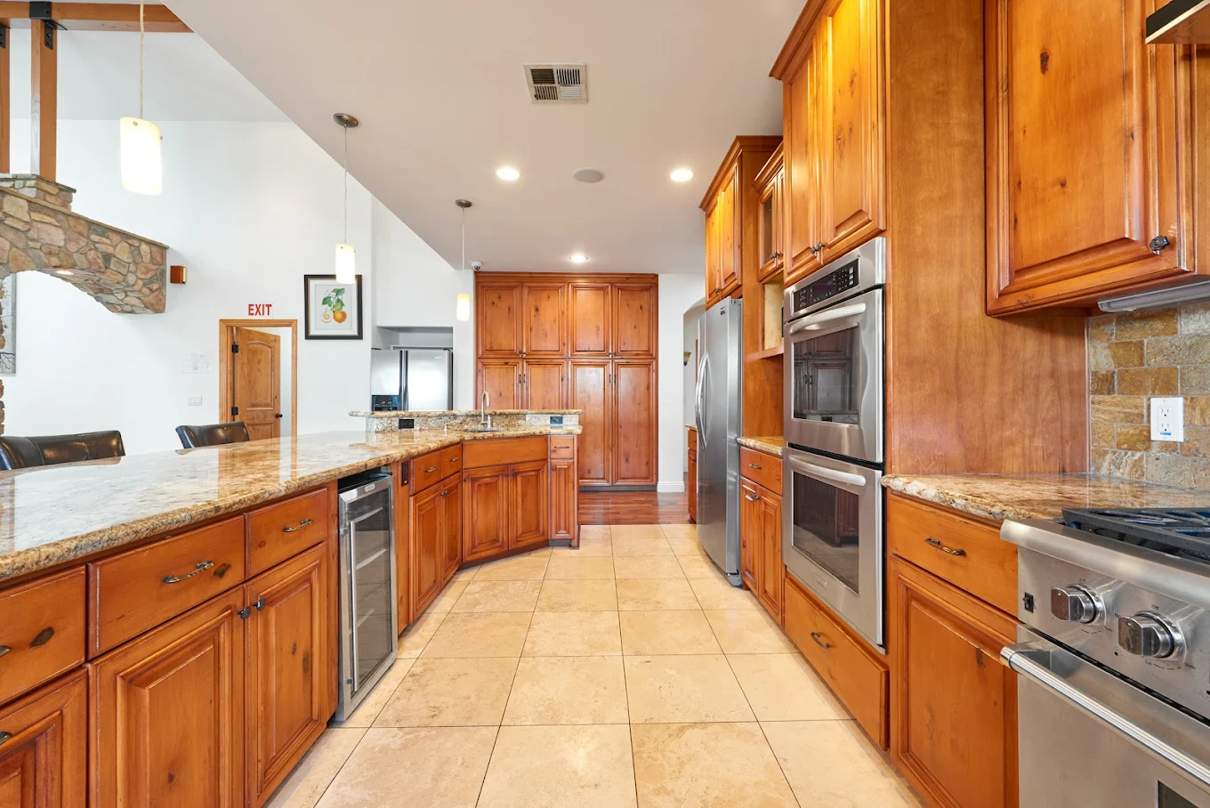 Spacious kitchen with wooden cabinets and granite countertops
