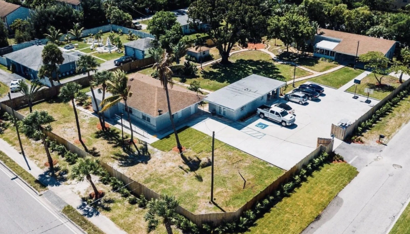 Aerial view of rehab facility with multiple buildings and green space.
