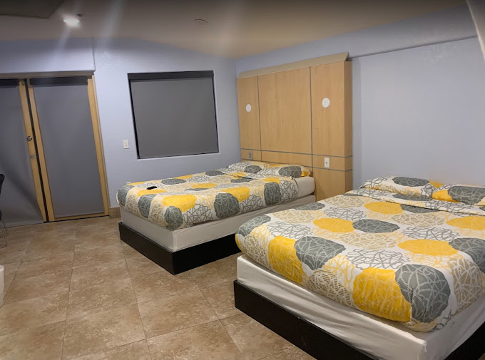 Clean bedroom with two beds and minimalist decor.