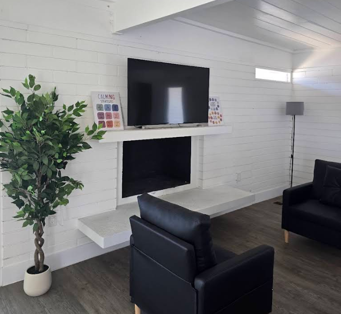 Living room with sofas, chairs, and mounted TV
