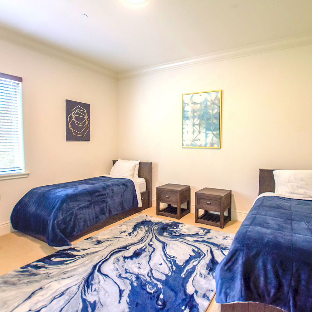 Bedroom with two beds and side tables.