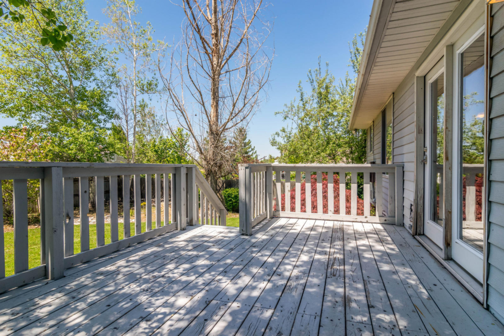 Wooden deck overlooking the green backyard