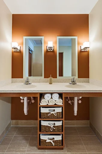 Elegant double-sink vanity with warm lighting and mirrors