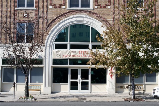 Front exterior of DYC Brooklyn with arched doorway and trees
