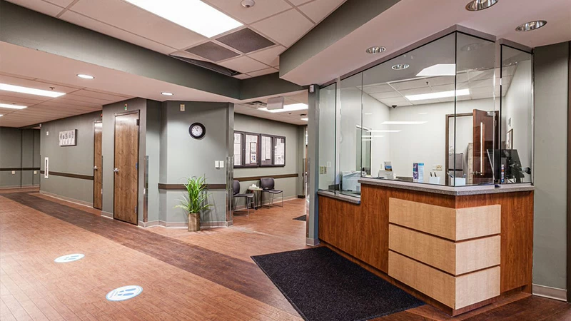 Reception desk with glass window in clinic lobby