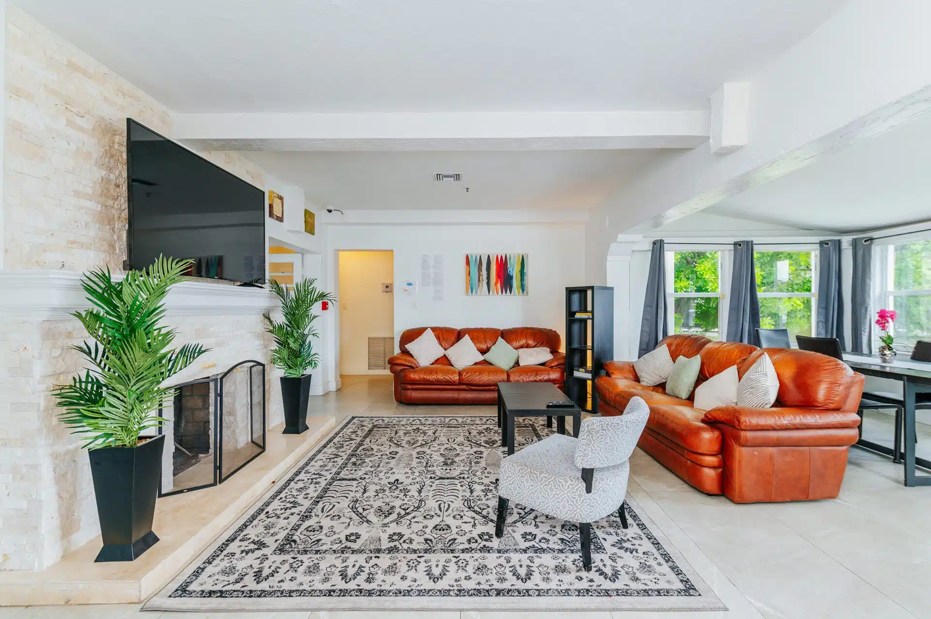 Cozy lounge with leather sofas and a dining area with large windows