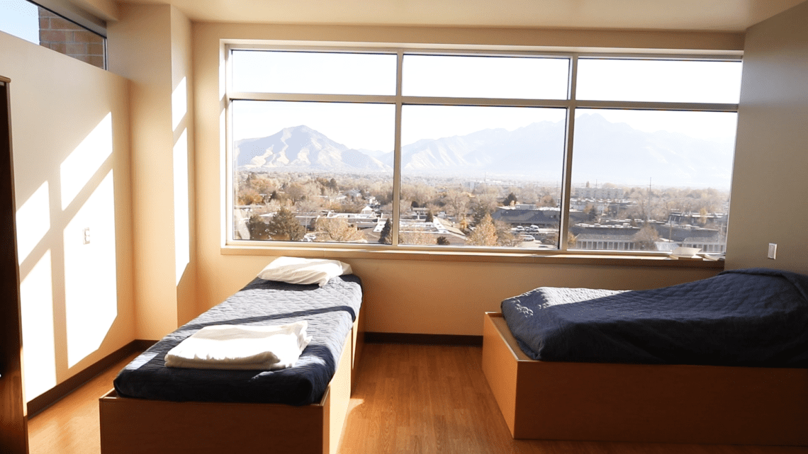 Two beds with mountain view from large window
