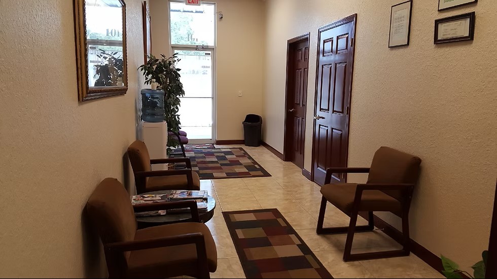 Clean, well-lit hallway with room doors and tile floor