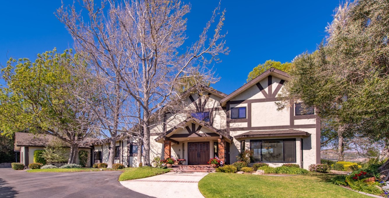 Facility front with tree-lined driveway.