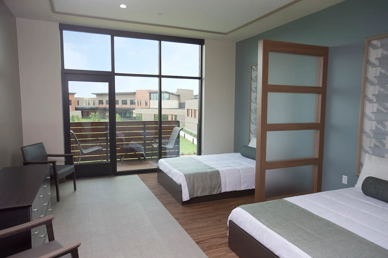 Bright double room with balcony overlooking landscaped campus