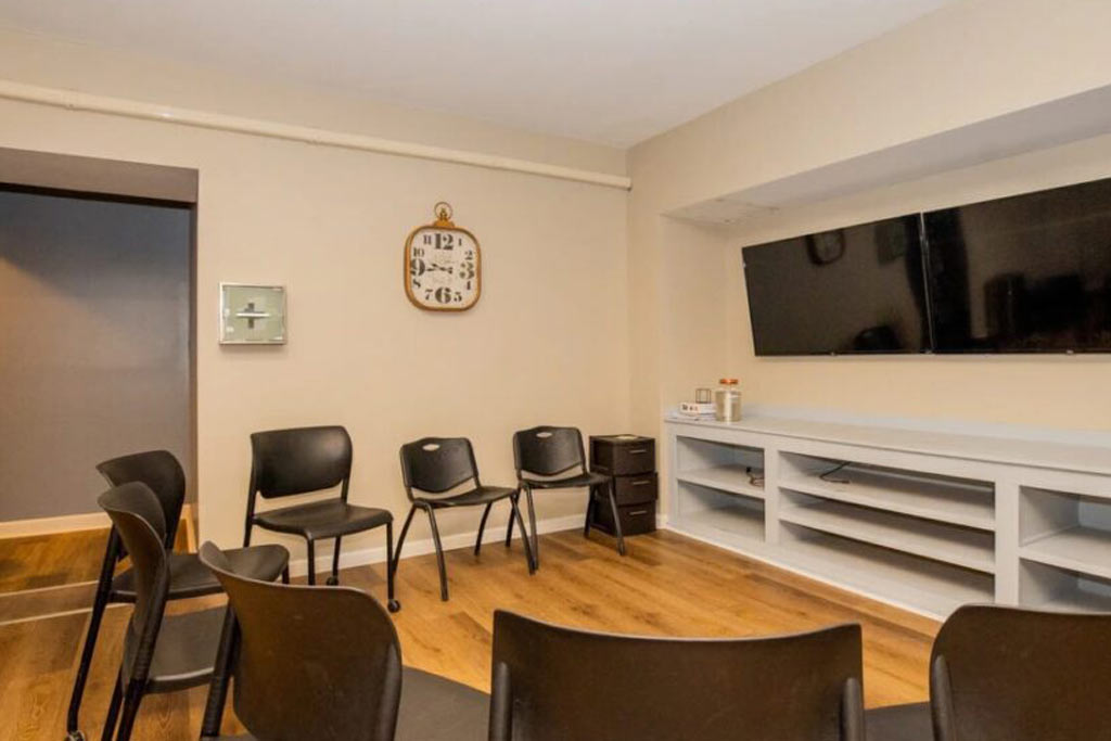 Circle of black chairs in a therapy meeting space