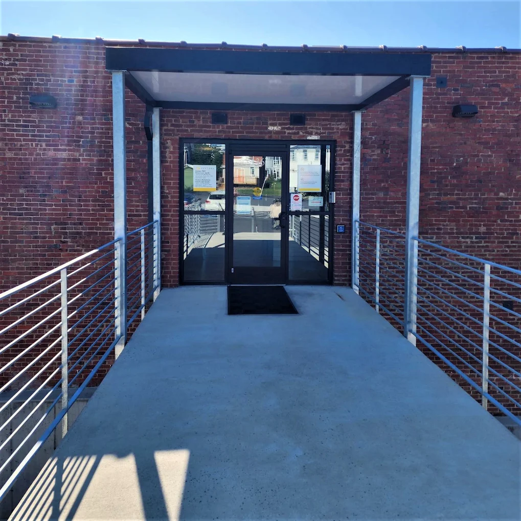 Accessible exterior entrance with ramp and glass doors at Master Center Harrisonburg