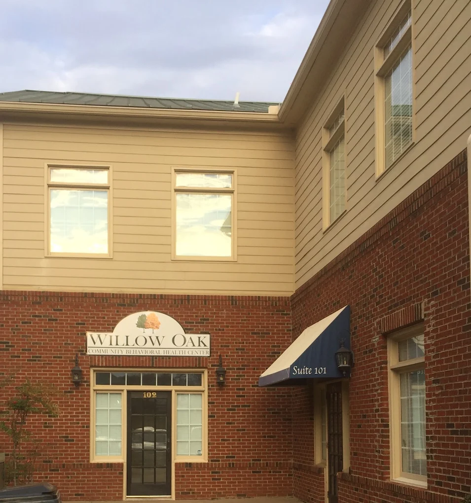 Brick building with Willow Oak sign above entrance door