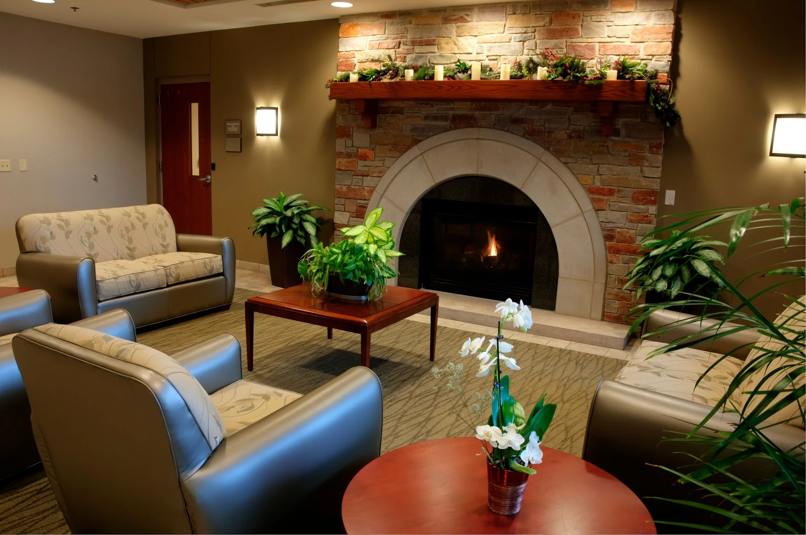 Cozy lounge with stone fireplace and armchairs