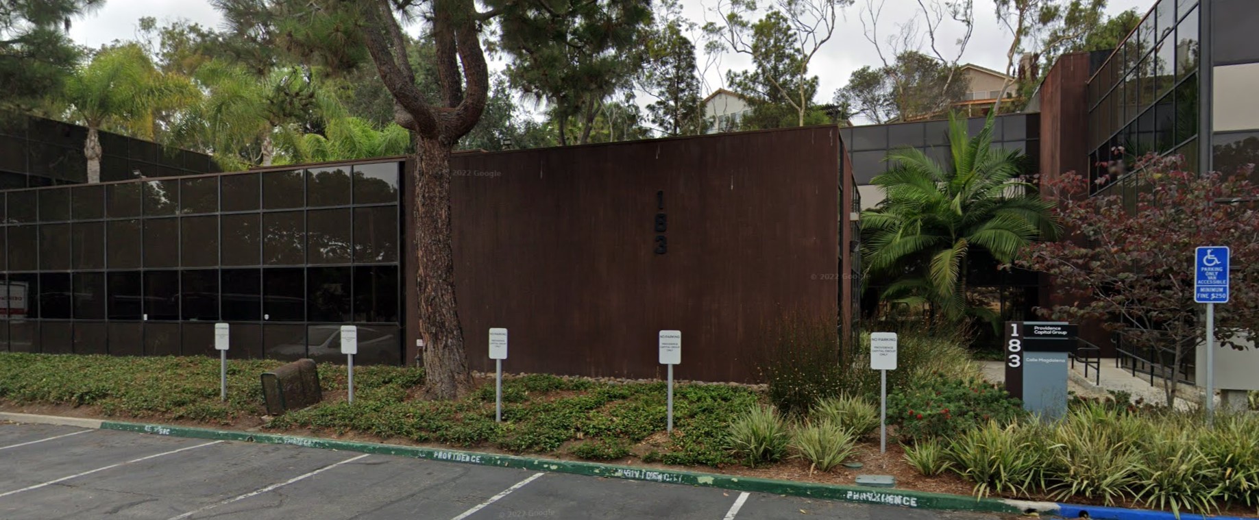 Parking and entrance pathway of Shoreline Recovery Center, featuring clean lines and lush landscaping.