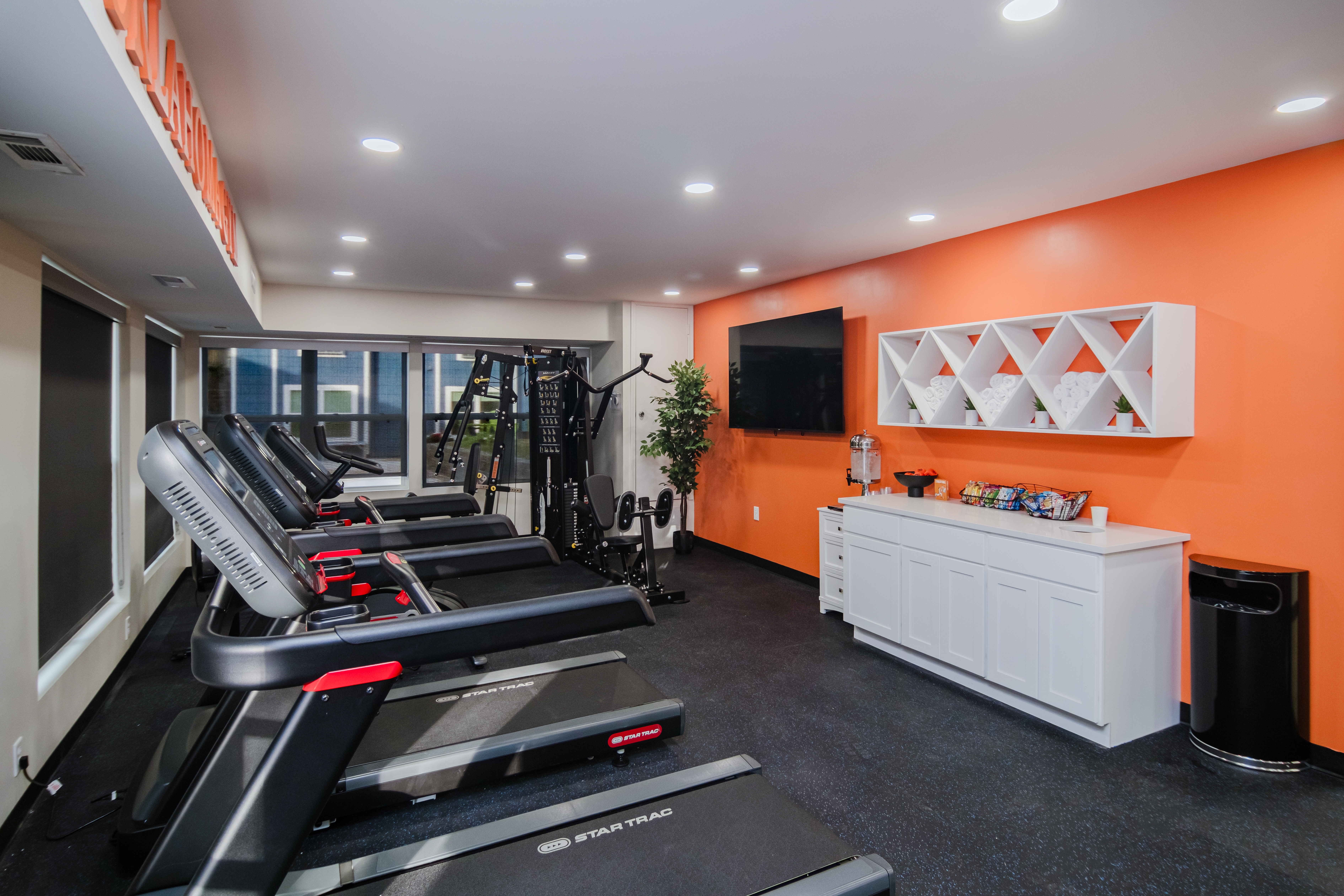 Fitness room with treadmills and strength equipment.