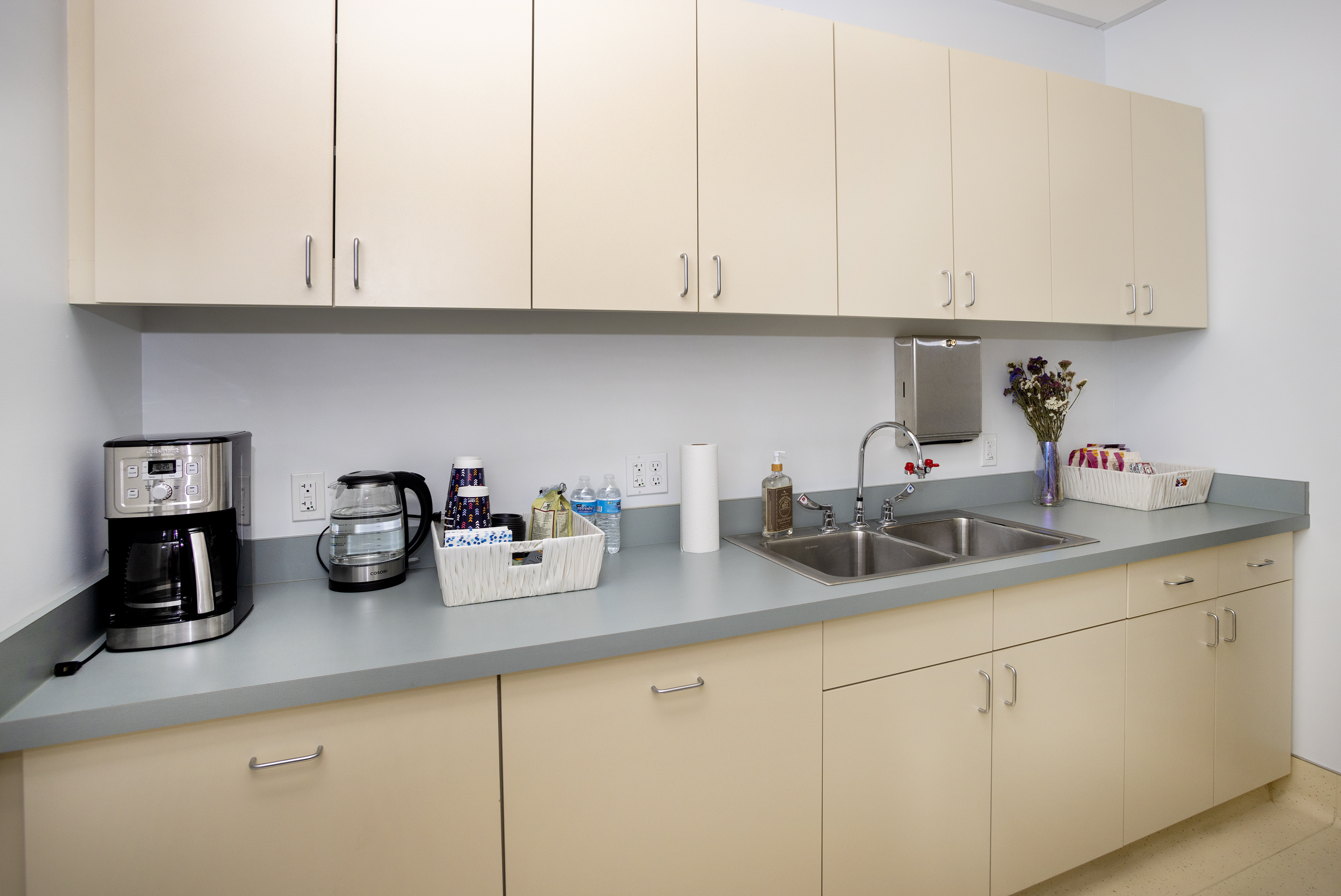 Countertop with coffee maker, sink, and snacks