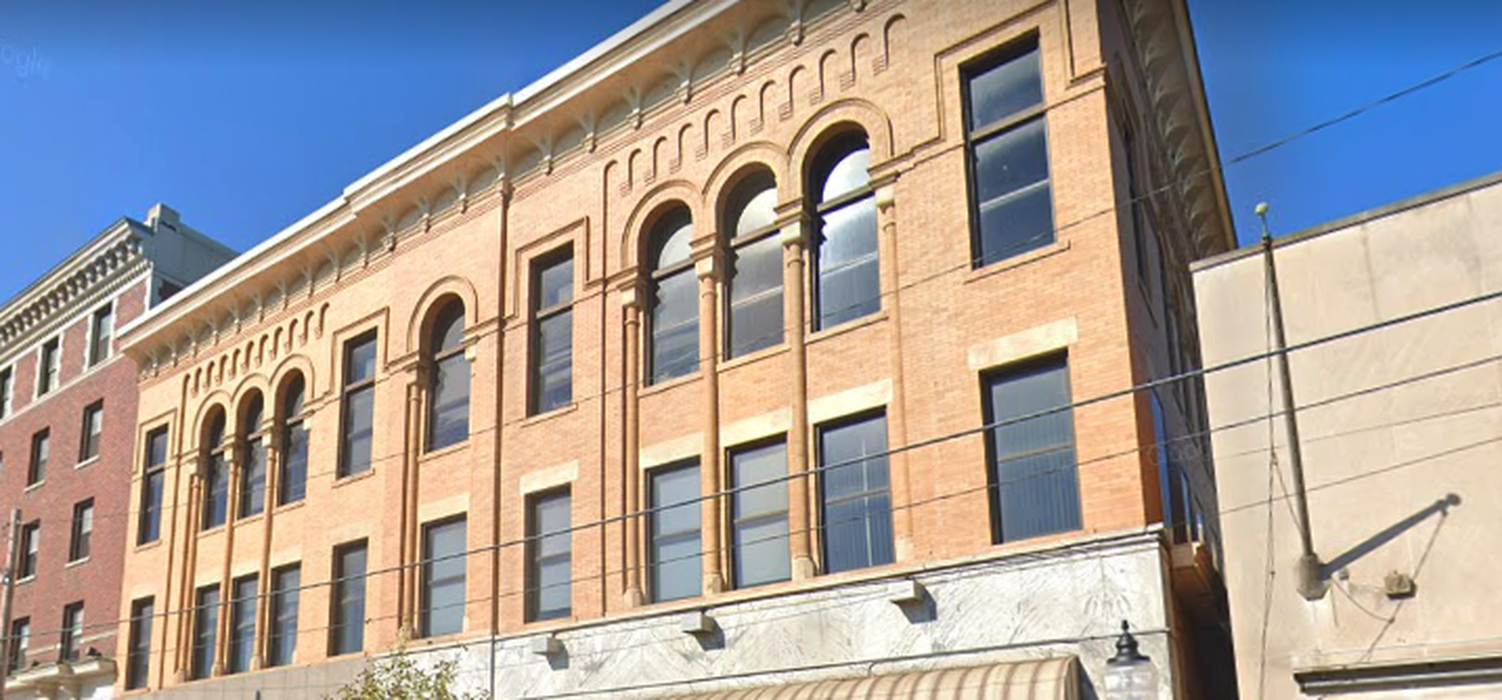 Historic brick building with arched windows and detailed trim