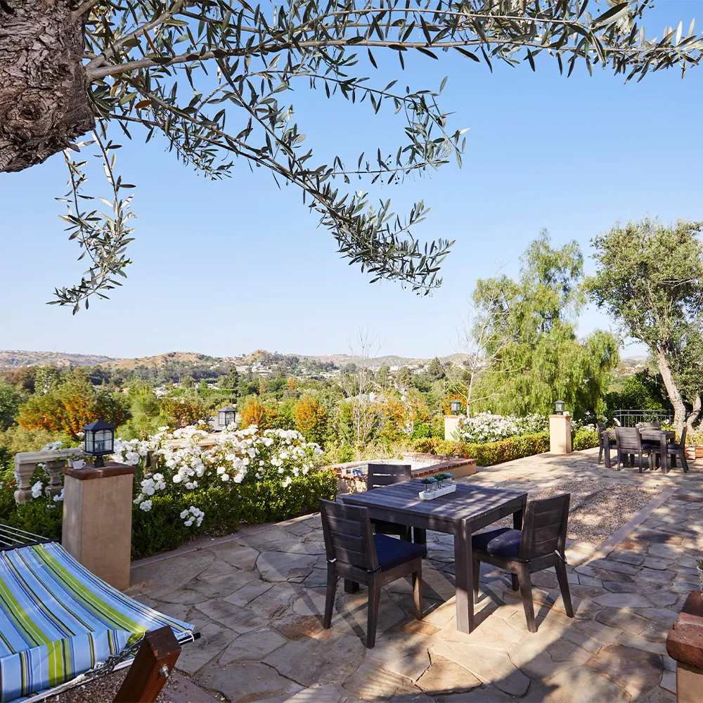 Patio with dining table and scenic hillside view