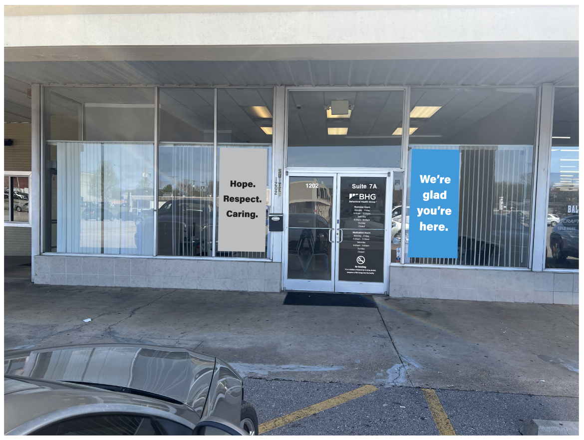 Glass front entrance with BHG branding and welcome decals