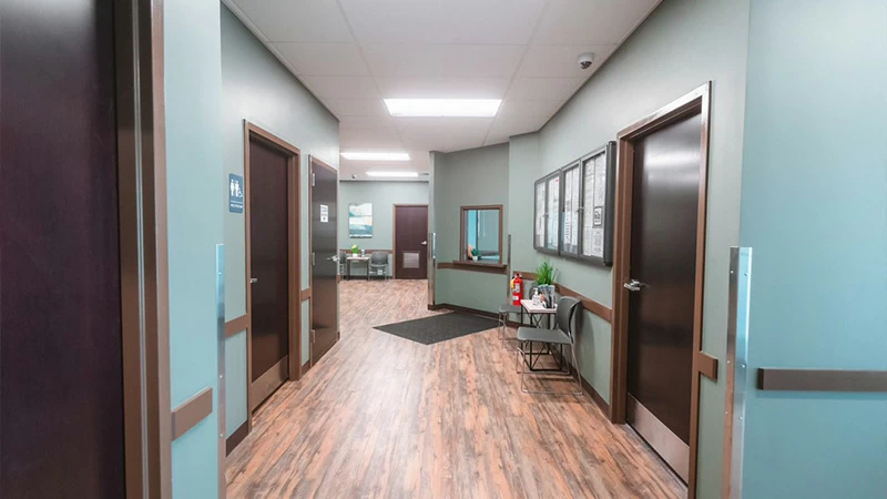 Hallway with patient rooms inside treatment facility