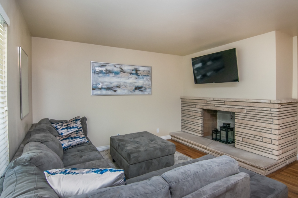 Spacious common area with seating and hardwood floors