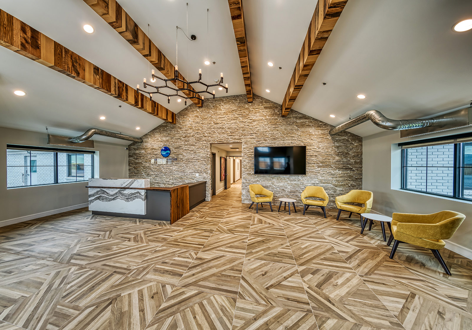 Stylish lobby with stone wall and yellow chairs