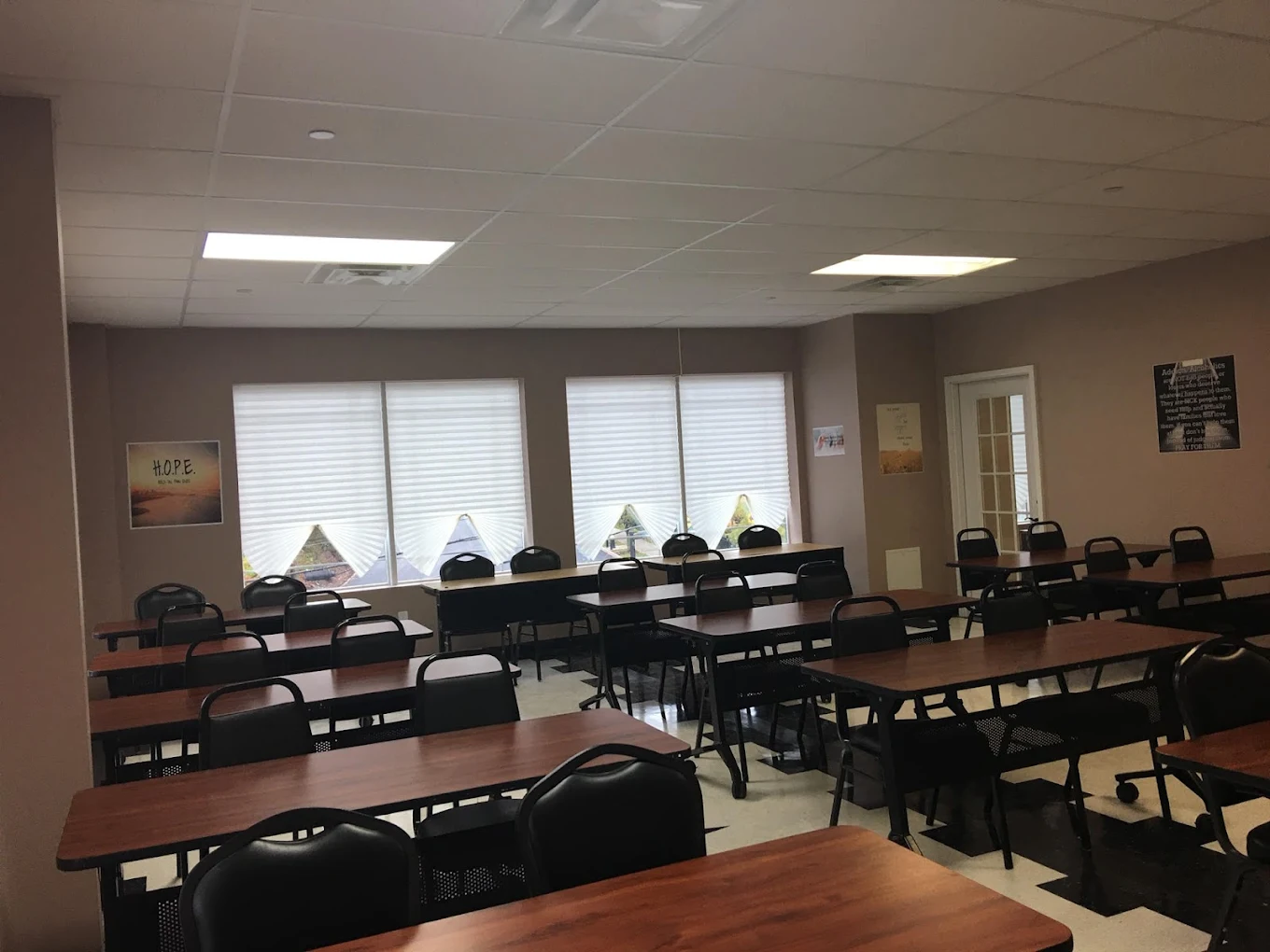 Classroom-style room with rows of tables and chairs