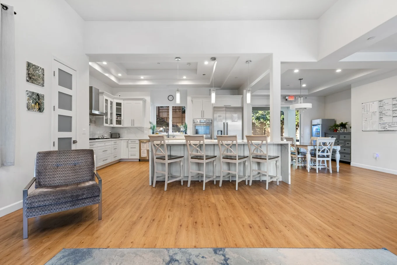 Open kitchen with island seating and modern lighting