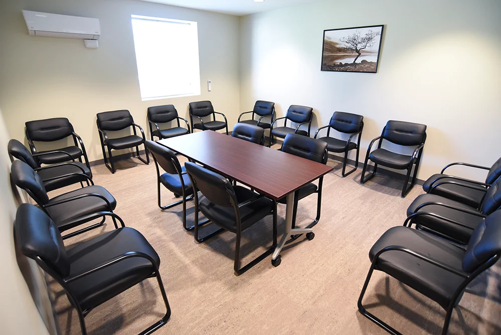 Group meeting room with black chairs arranged around a table