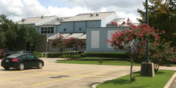 Modern rehab facility with parking and landscaped grounds