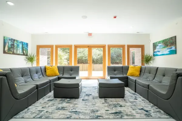 Spacious group room with gray sectional seating.