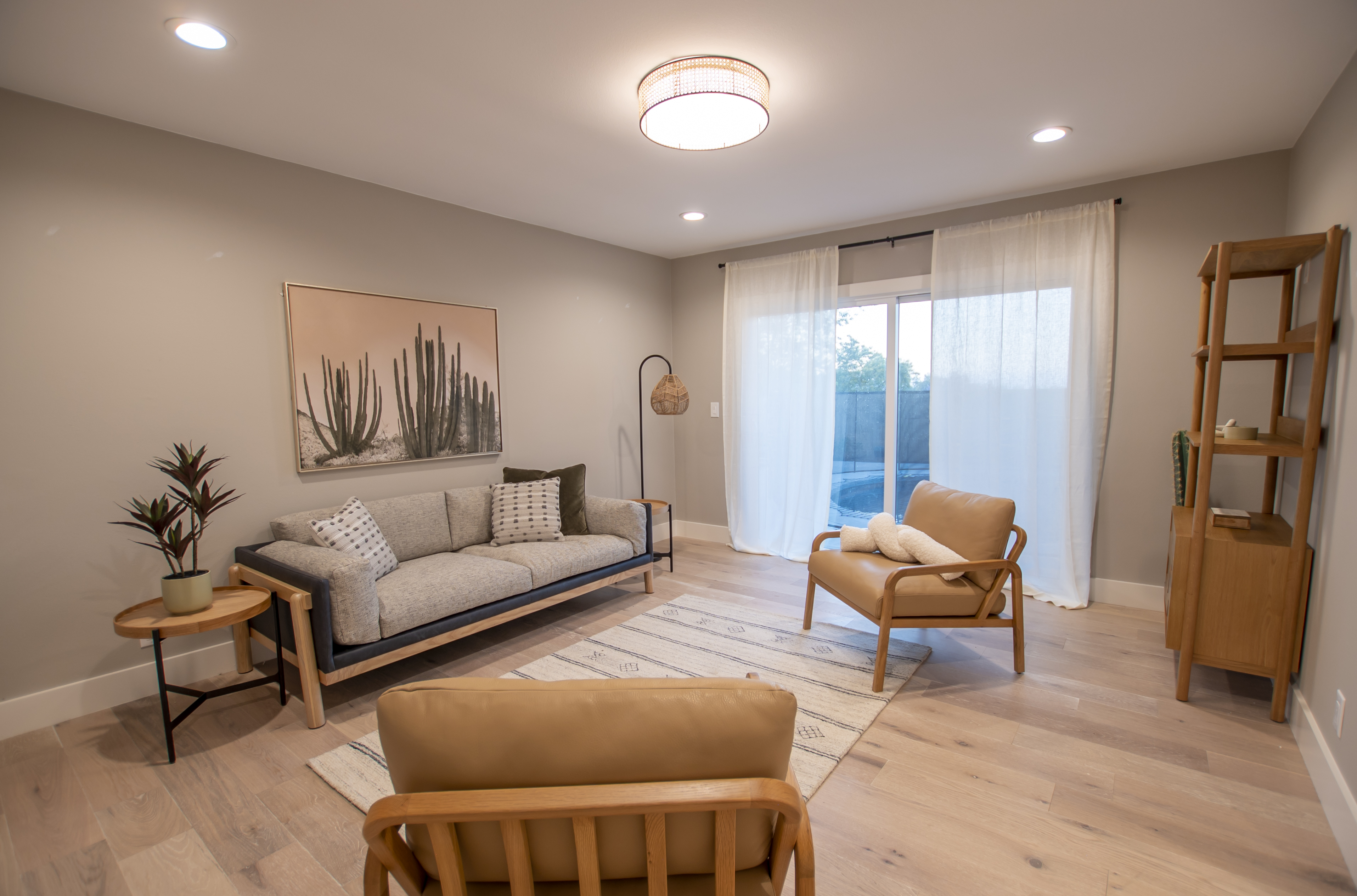 Neutral-toned room with cactus art and sliding door