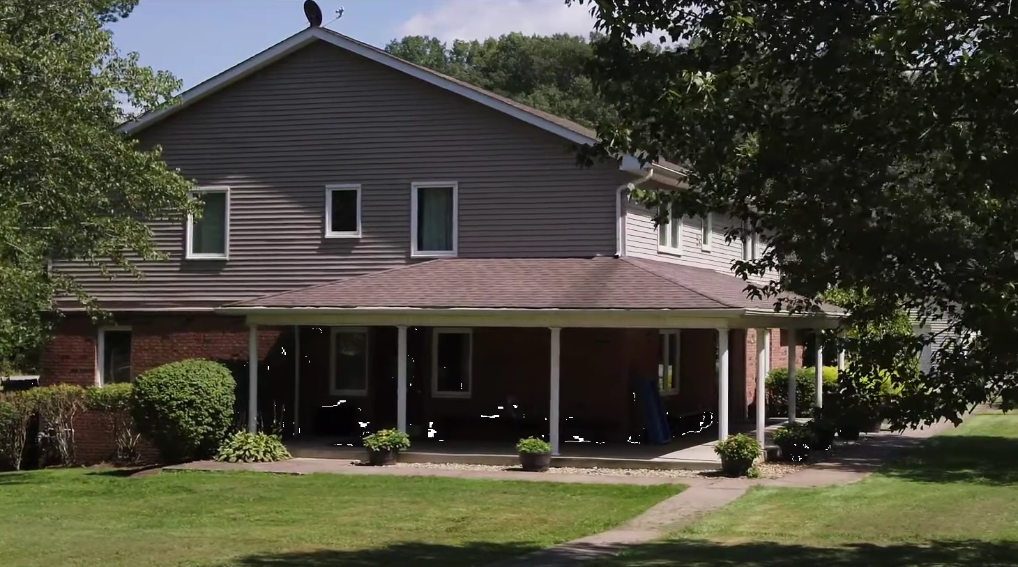 Residential recovery facility building surrounded by trees and lawn
