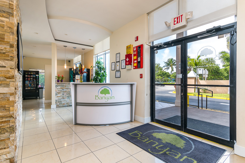 Rception with signage on desk and a vending machine.