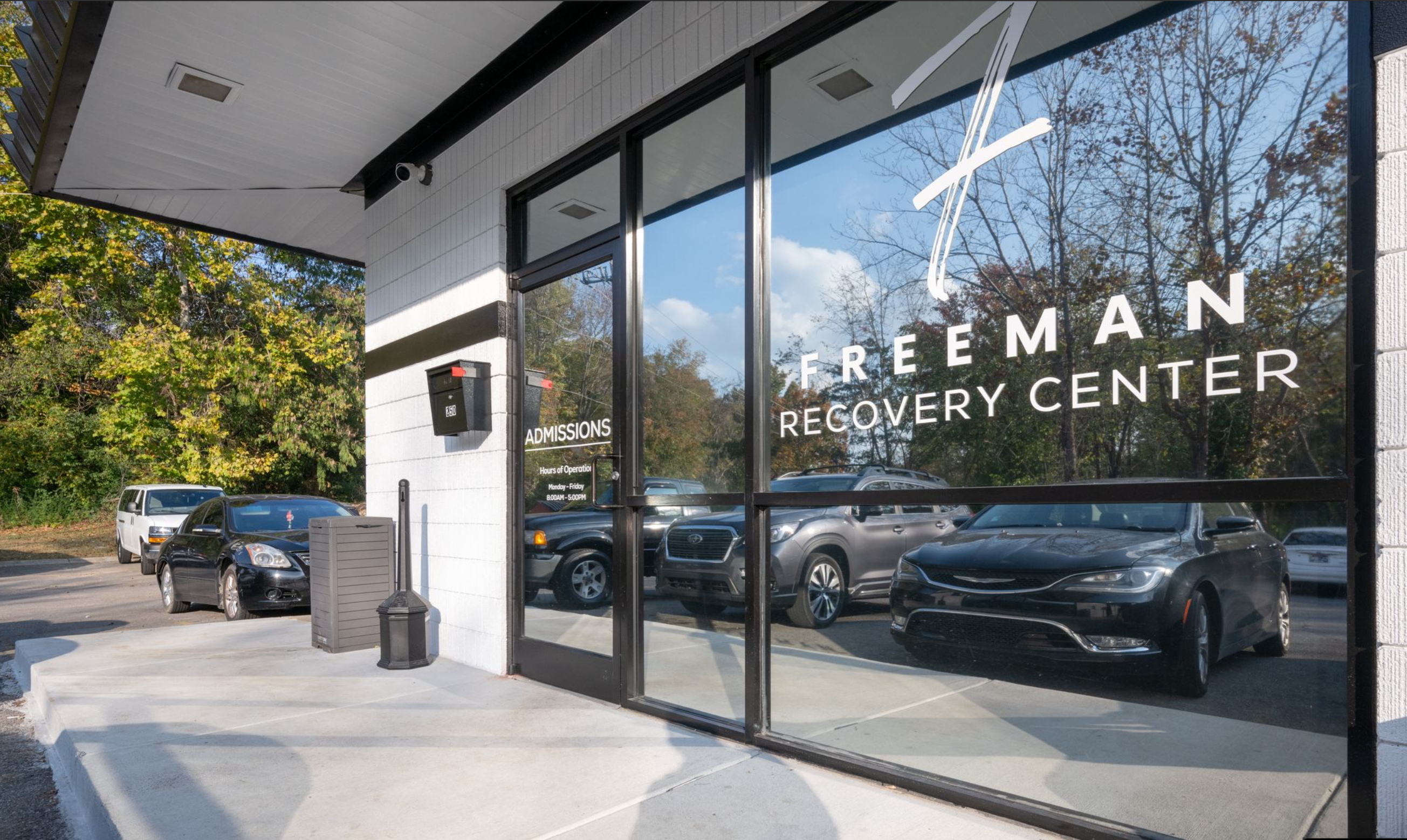 Glass door with admissions hours at Freeman Recovery Center
