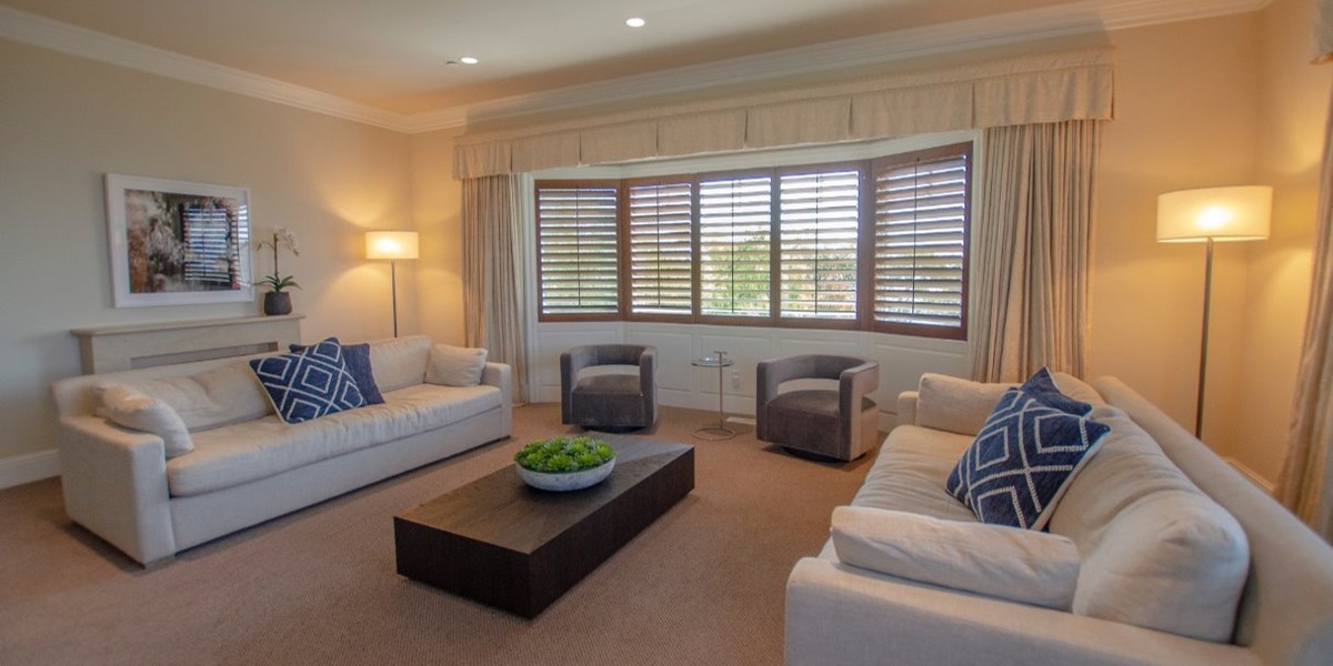 Comfortable lounge with sofas and large windows.