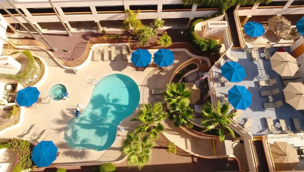  Aerial view of backyard pool area with lounge chairs.