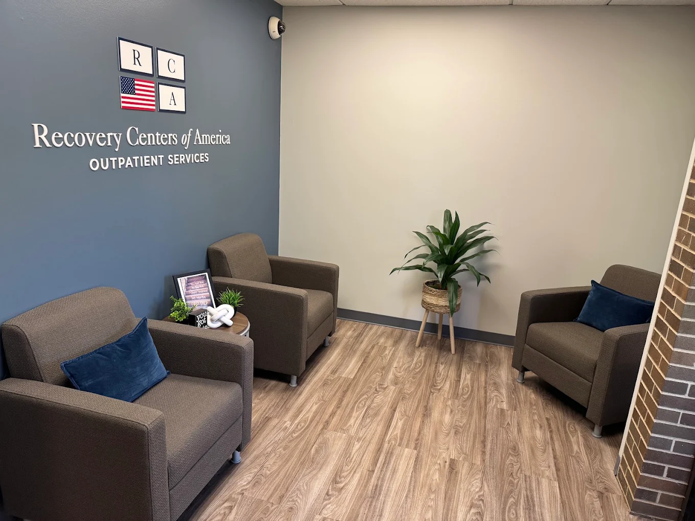 Waiting area with armchairs and outpatient services wall sign