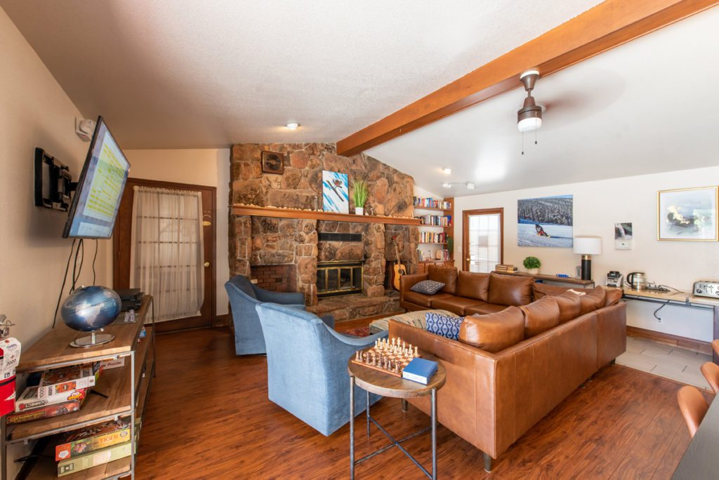 Living room with brown sofas and stone fireplace