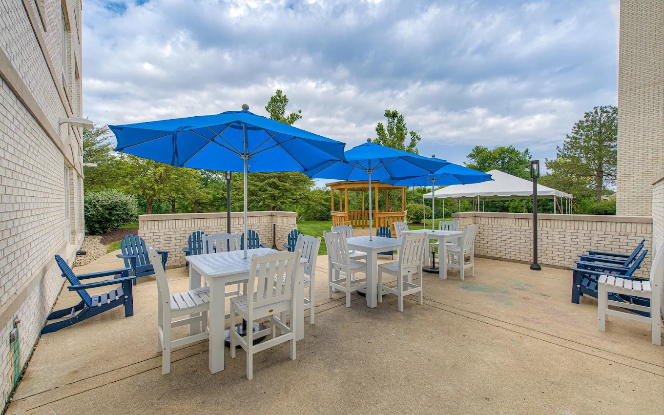 Patio with white tables and blue umbrellas