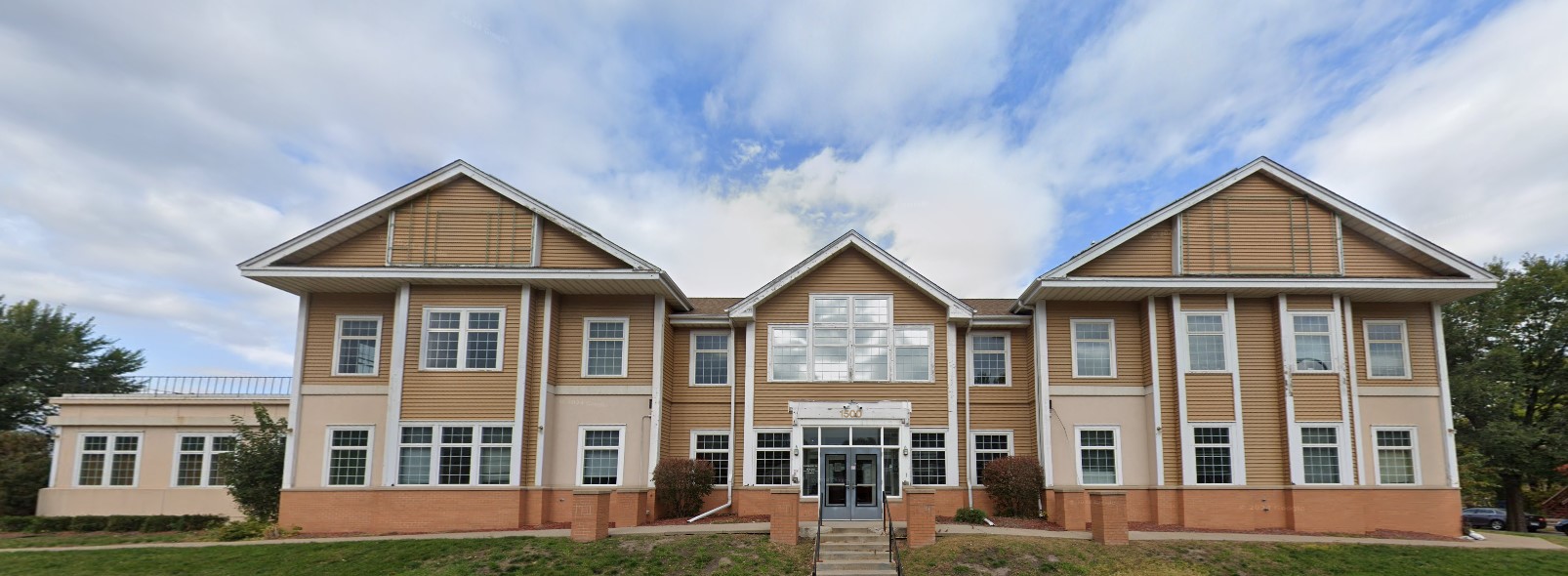 Exterior front view of the rehab facility with stairs to entrance.