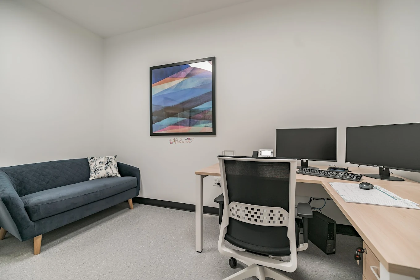 Counseling office with desk, computer, and seating
